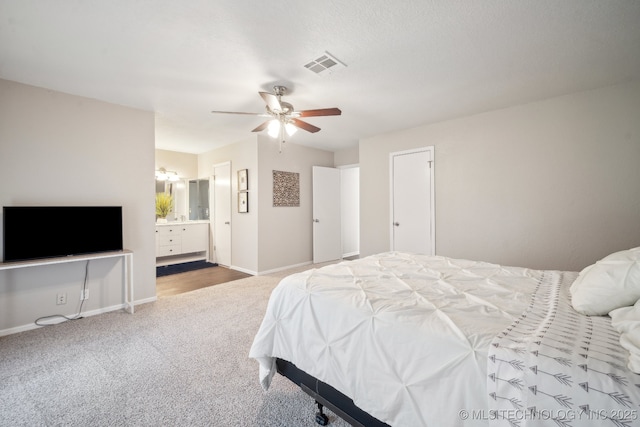6505 E 47th St, Tulsa, OK 74145 - carpeted bedroom featuring baseboards, ensuite bathroom, and a ceiling fan