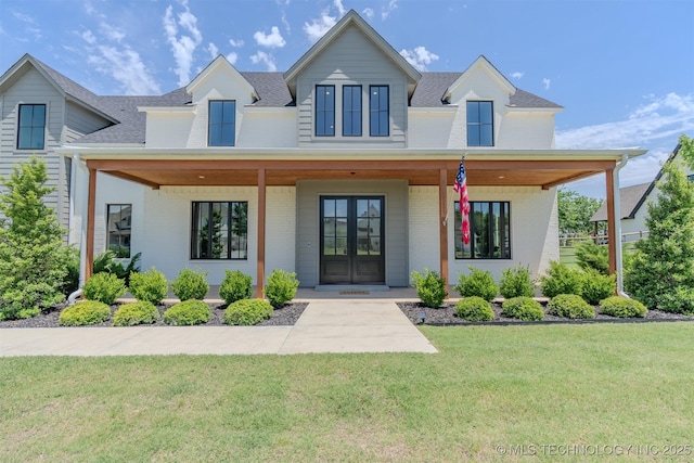 6407 N Blue Sage Dr, Owasso, OK 74055 - view of front of property featuring french doors, brick siding, a front lawn, a shingled roof, and covered porch