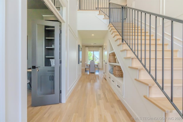 6407 N Blue Sage Dr, Owasso, OK 74055 - foyer featuring wood finished floors, stairway, and baseboards