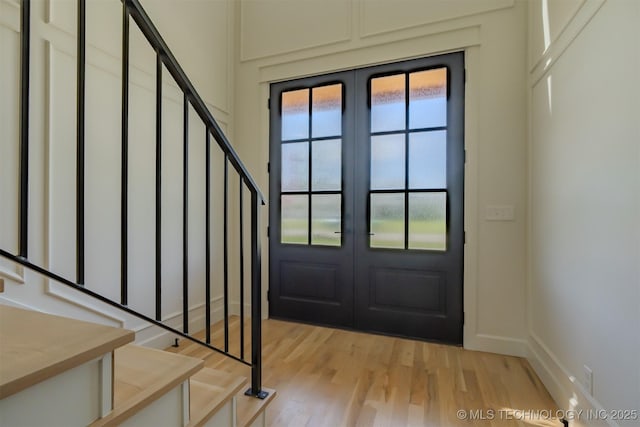 6407 N Blue Sage Dr, Owasso, OK 74055 - foyer entrance featuring french doors, stairway, and light wood-type flooring