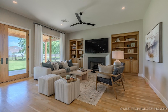 6407 N Blue Sage Dr, Owasso, OK 74055 - living area featuring a fireplace, light wood-style floors, baseboards, ceiling fan, and recessed lighting