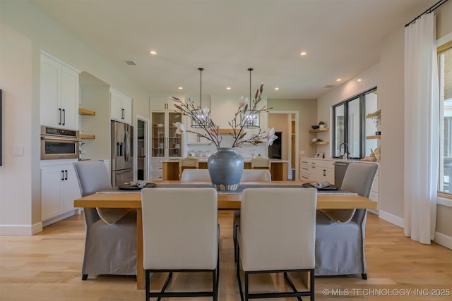6407 N Blue Sage Dr, Owasso, OK 74055 - dining room featuring light wood finished floors, healthy amount of natural light, recessed lighting, a chandelier, and baseboards