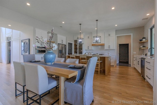 6407 N Blue Sage Dr, Owasso, OK 74055 - dining room with light wood-style floors and recessed lighting