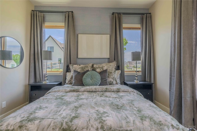 6407 N Blue Sage Dr, Owasso, OK 74055 - bedroom with multiple windows and baseboards