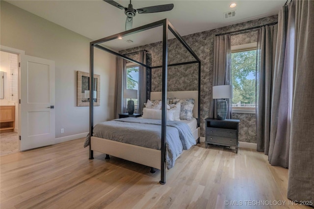 6407 N Blue Sage Dr, Owasso, OK 74055 - bedroom featuring wallpapered walls, wood finished floors, baseboards, ensuite bath, and a ceiling fan