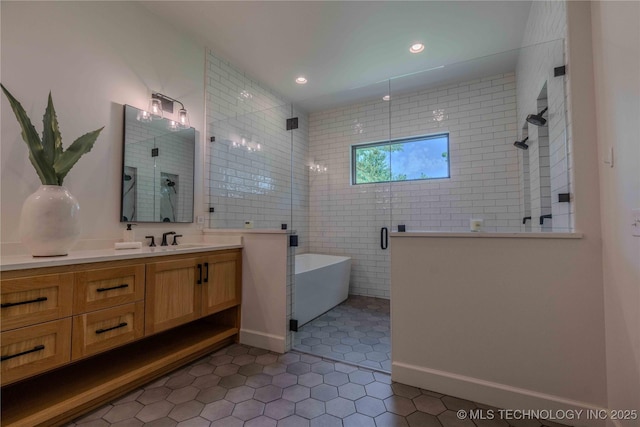 6407 N Blue Sage Dr, Owasso, OK 74055 - bathroom with tile patterned floors, a shower stall, vanity, a freestanding tub, and recessed lighting