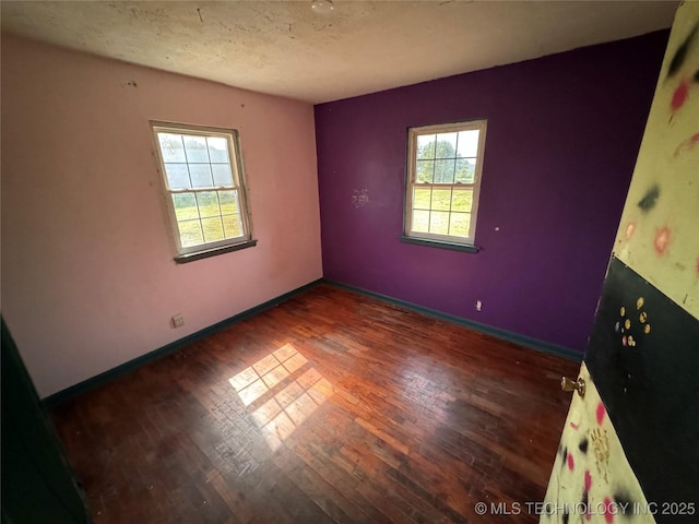 18700 E 600th Rd, Inola, OK 74036 - unfurnished room featuring wood finished floors, baseboards, and a textured ceiling