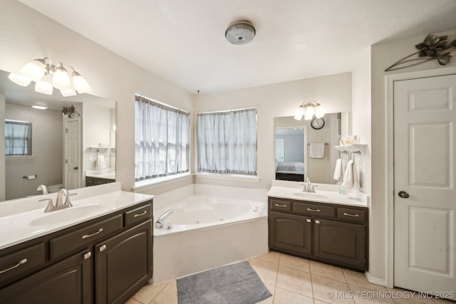 full bathroom with tile patterned floors, a jetted tub, two vanities, and ensuite bathroom