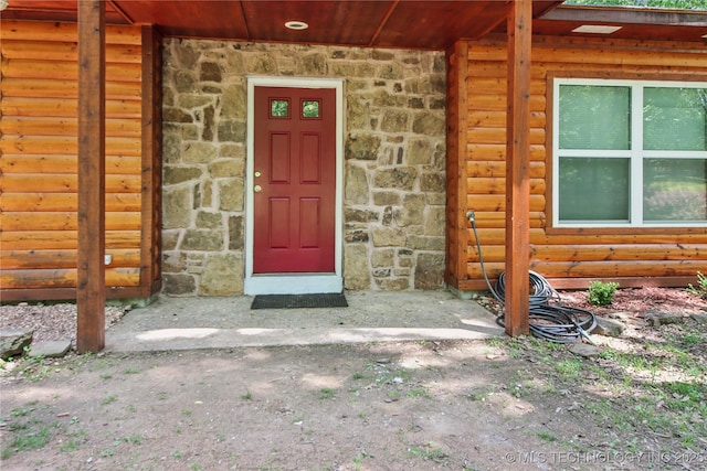 doorway to property with stone siding
