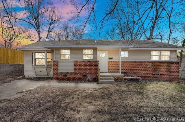 233 N 44th W Ave, Tulsa, OK 74127 - view of front of home with brick siding, crawl space, and fence