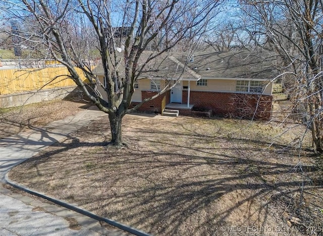 233 N 44th W Ave, Tulsa, OK 74127 - view of front of property with fence and brick siding