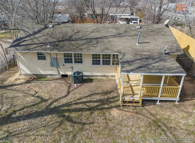 233 N 44th W Ave, Tulsa, OK 74127 - rear view of property with a shingled roof, central air condition unit, and fence