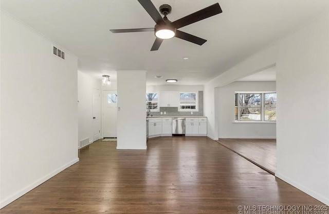 233 N 44th W Ave, Tulsa, OK 74127 - unfurnished living room with dark wood-style flooring, a ceiling fan, and baseboards