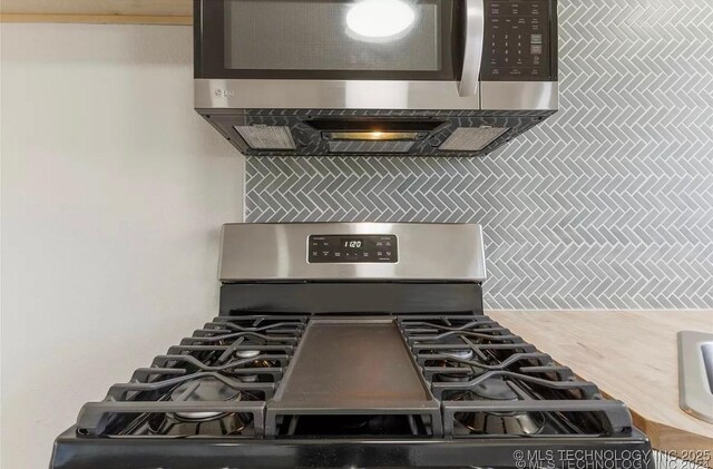 233 N 44th W Ave, Tulsa, OK 74127 - kitchen with appliances with stainless steel finishes and tasteful backsplash