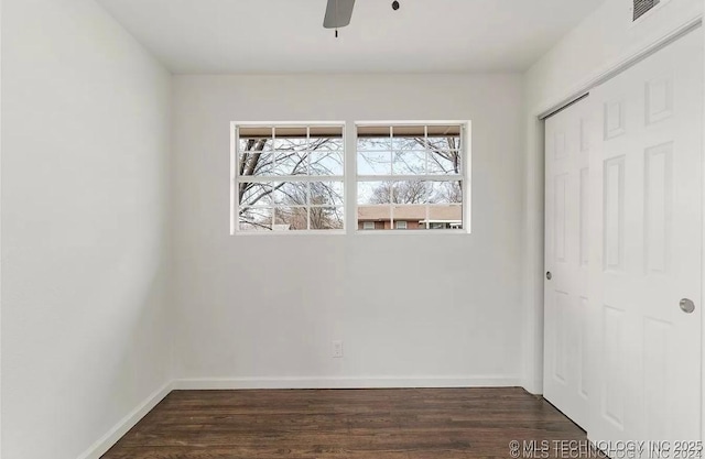 233 N 44th W Ave, Tulsa, OK 74127 - unfurnished bedroom with dark wood finished floors, a closet, baseboards, and ceiling fan