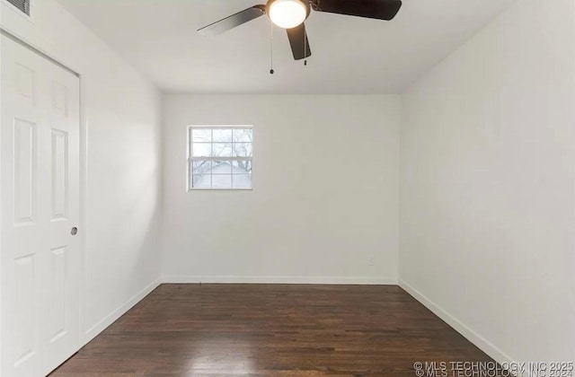 233 N 44th W Ave, Tulsa, OK 74127 - unfurnished bedroom featuring baseboards, dark wood-style floors, and ceiling fan