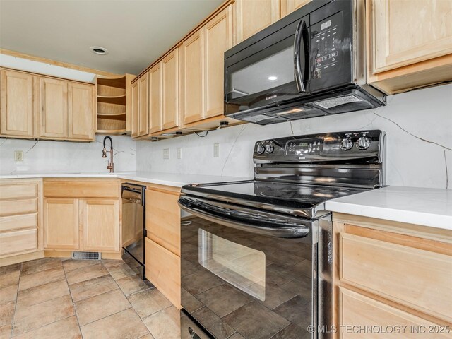 7446 E 20th St, Tulsa, OK 74112 - kitchen with black appliances, light brown cabinetry, open shelves, and light countertops