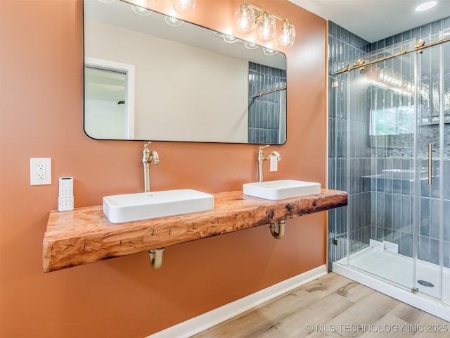7446 E 20th St, Tulsa, OK 74112 - full bathroom featuring wood finished floors, a shower stall, and double sink