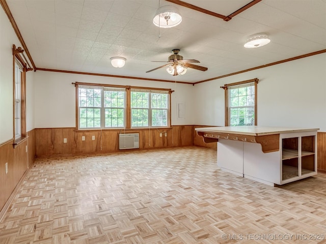 7446 E 20th St, Tulsa, OK 74112 - empty room featuring wainscoting, wooden walls, ceiling fan, crown molding, and a wall mounted air conditioner