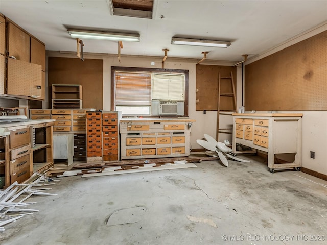 7446 E 20th St, Tulsa, OK 74112 - kitchen featuring unfinished concrete flooring, cooling unit, and brown cabinets