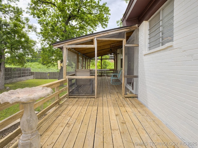 7446 E 20th St, Tulsa, OK 74112 - deck featuring a sunroom and a fenced backyard