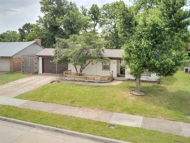 7446 E 20th St, Tulsa, OK 74112 - view of front facade with concrete driveway, a garage, a front lawn, central air condition unit, and stucco siding