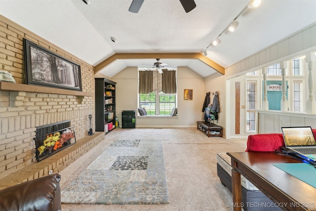 9599 E 155th Ave N, Owasso, OK 74055 - carpeted living room featuring ceiling fan, a brick fireplace, vaulted ceiling, a textured ceiling, and baseboards