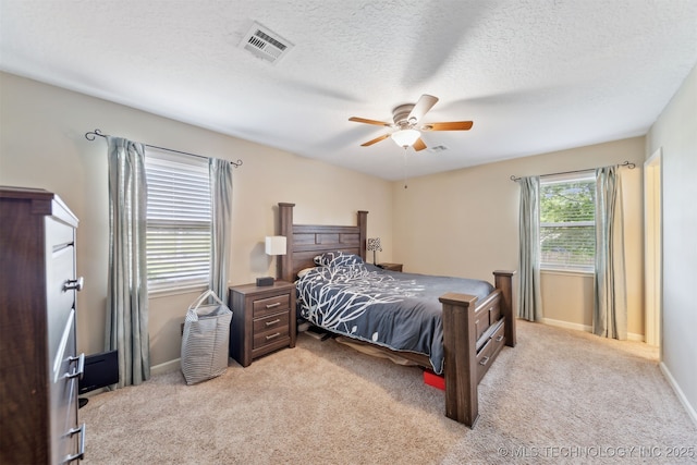 9599 E 155th Ave N, Owasso, OK 74055 - carpeted bedroom featuring baseboards, ceiling fan, and a textured ceiling