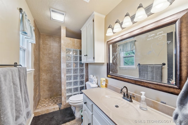 9599 E 155th Ave N, Owasso, OK 74055 - bathroom featuring walk in shower, toilet, and vanity