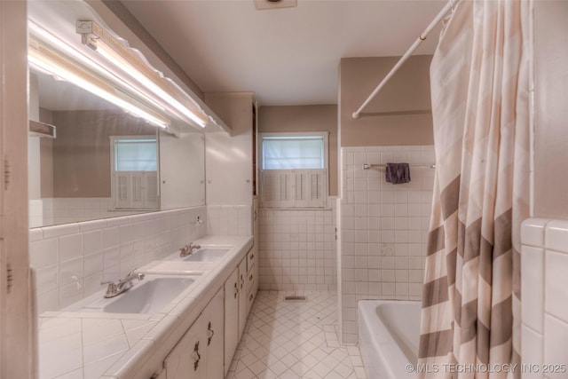 5102 S Columbia Ave, Tulsa, OK 74105 - bathroom with tile walls, tile patterned floors, double vanity, shower / tub combo, and wainscoting