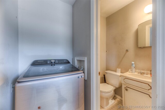 5102 S Columbia Ave, Tulsa, OK 74105 - bathroom featuring washer / clothes dryer, toilet, and vanity