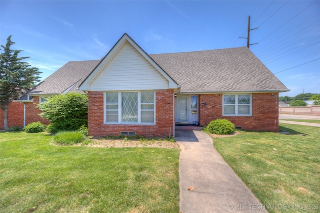 5102 S Columbia Ave, Tulsa, OK 74105 - view of front of property featuring brick siding, a front yard, and a shingled roof