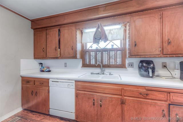 5102 S Columbia Ave, Tulsa, OK 74105 - kitchen with dishwasher, light countertops, brown cabinets, wood finished floors, and crown molding