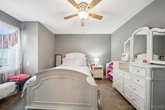bedroom with dark colored carpet and a ceiling fan