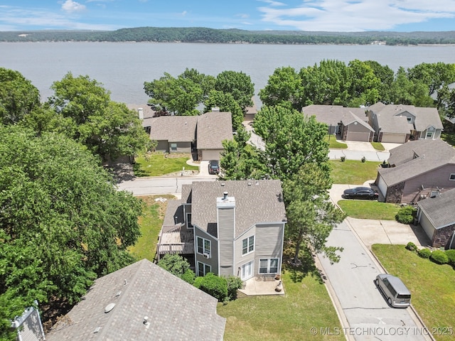 aerial view of residential area with a large body of water