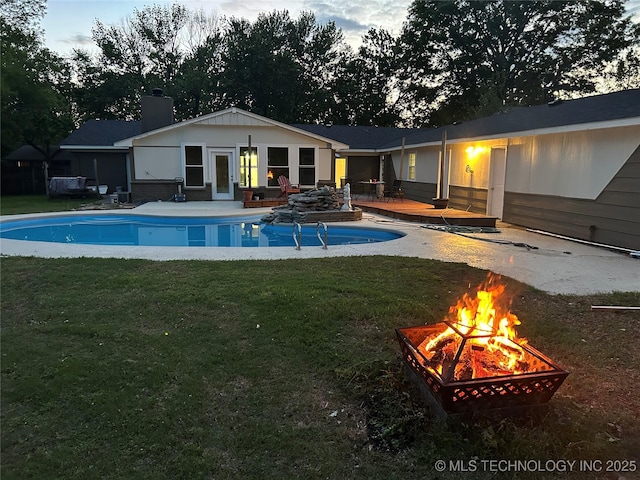 11815 S 86th E Ave, Bixby, OK 74008 - rear view of property with a fire pit, a wooden deck, a chimney, and a lawn