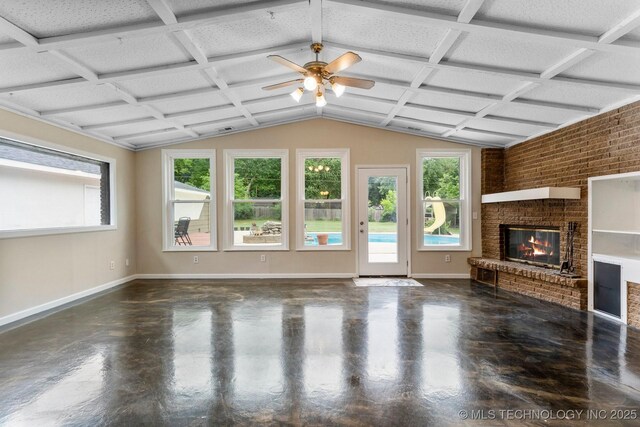 11815 S 86th E Ave, Bixby, OK 74008 - unfurnished living room featuring finished concrete flooring, plenty of natural light, a fireplace, a ceiling fan, and lofted ceiling