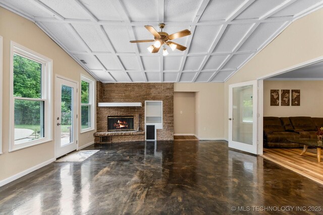 11815 S 86th E Ave, Bixby, OK 74008 - unfurnished living room featuring baseboards, ceiling fan, concrete floors, and a brick fireplace