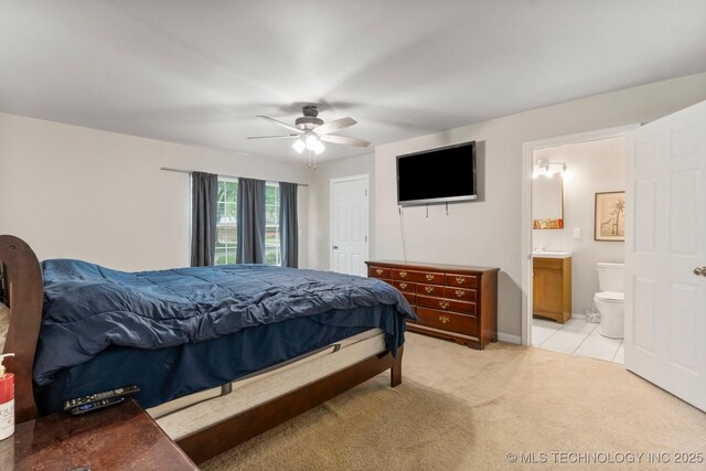 11815 S 86th E Ave, Bixby, OK 74008 - bedroom with light carpet, connected bathroom, ceiling fan, and baseboards