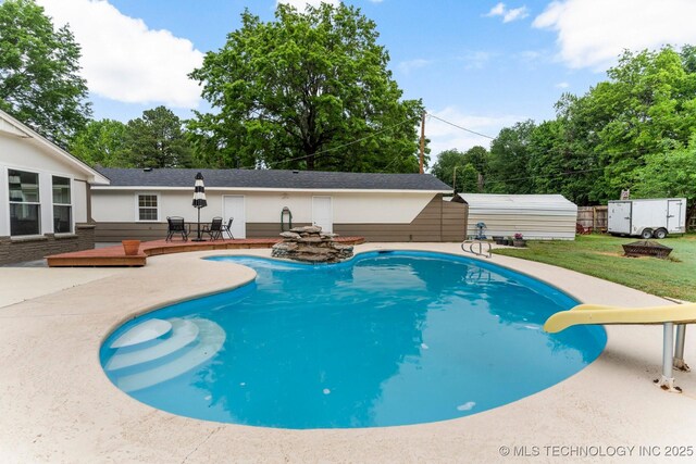 11815 S 86th E Ave, Bixby, OK 74008 - outdoor pool featuring a storage unit, an outbuilding, a patio, a water slide, and a lawn