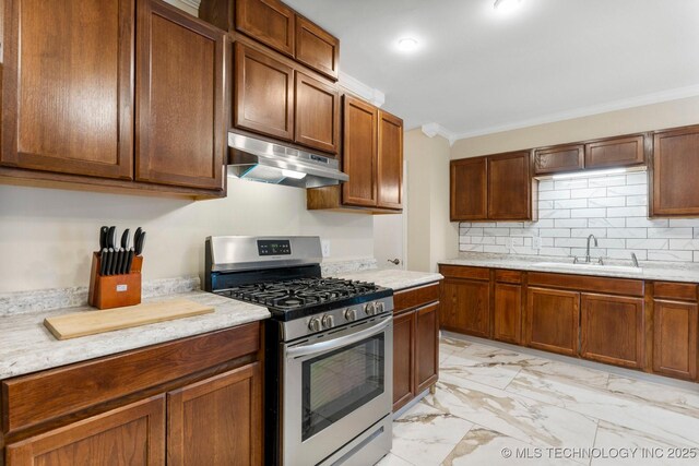 11815 S 86th E Ave, Bixby, OK 74008 - kitchen with stainless steel gas stove, under cabinet range hood, a sink, light marble finish flooring, and ornamental molding