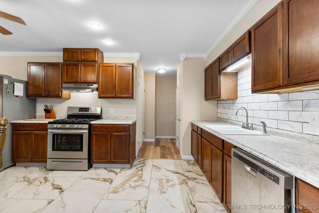 11815 S 86th E Ave, Bixby, OK 74008 - kitchen featuring stainless steel appliances, under cabinet range hood, a sink, light marble finish floors, and light countertops