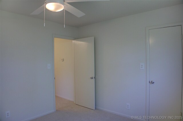 4601 S 66th Ave E, Tulsa, OK 74145 - unfurnished bedroom featuring light colored carpet, baseboards, and a ceiling fan