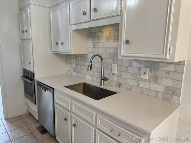 4601 S 66th Ave E, Tulsa, OK 74145 - kitchen featuring appliances with stainless steel finishes, a sink, light countertops, and decorative backsplash