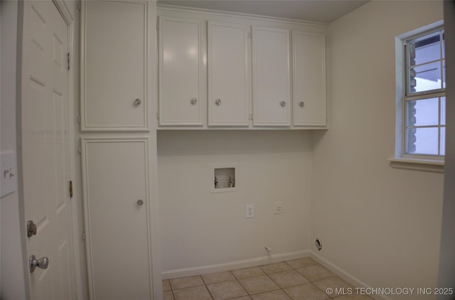 4601 S 66th Ave E, Tulsa, OK 74145 - washroom featuring cabinet space, washer hookup, light tile patterned flooring, and baseboards