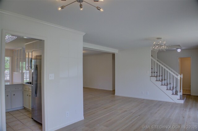 4601 S 66th Ave E, Tulsa, OK 74145 - empty room with a chandelier, stairs, light wood finished floors, ornamental molding, and baseboards