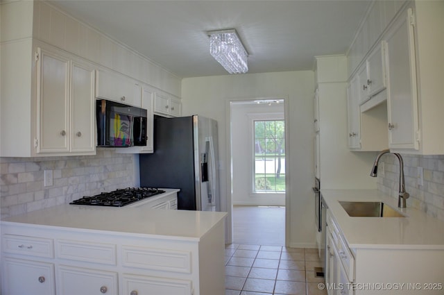 4601 S 66th Ave E, Tulsa, OK 74145 - kitchen with black appliances, a sink, backsplash, white cabinets, and light countertops