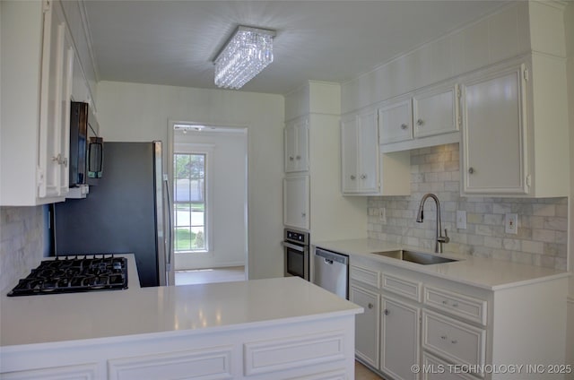 4601 S 66th Ave E, Tulsa, OK 74145 - kitchen featuring a sink, black appliances, light countertops, and backsplash