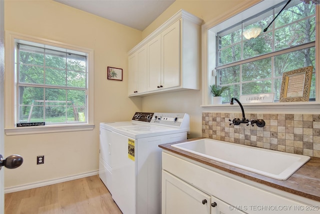21304 S 4200th Rd, Claremore, OK 74019 - laundry area with cabinet space, separate washer and dryer, healthy amount of natural light, and light wood-style floors