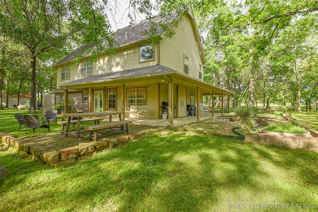 21304 S 4200th Rd, Claremore, OK 74019 - back of property with a patio, a lawn, and roof with shingles